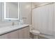 Bright bathroom featuring a sleek vanity, backlit mirror, and a shower-tub combination with a clean, minimalist design at 17522 Hidden Forest Dr, Clermont, FL 34714