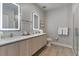 Modern bathroom featuring illuminated mirrors, a spacious vanity, and a glass-enclosed shower with a sleek design at 17522 Hidden Forest Dr, Clermont, FL 34714
