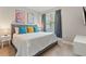 Cozy bedroom featuring a plush bed with colorful pillows and art, complemented by curtains that filter natural light at 17522 Hidden Forest Dr, Clermont, FL 34714