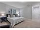 This bedroom features stylish wall paneling, cool artwork, and blue bedside tables, creating a serene atmosphere at 17522 Hidden Forest Dr, Clermont, FL 34714