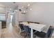 Bright dining area features modern table with seating for six and contemporary light fixture at 17522 Hidden Forest Dr, Clermont, FL 34714