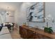 Dining area with a white table, modern chandelier, and view of the living room's stylish decor at 17522 Hidden Forest Dr, Clermont, FL 34714