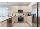 Modern kitchen with stainless steel appliances, quartz countertops and light wood cabinets at 17522 Hidden Forest Dr, Clermont, FL 34714