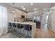 Contemporary kitchen with stainless steel appliances, quartz countertops, and breakfast bar with seating at 17522 Hidden Forest Dr, Clermont, FL 34714