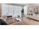 Living room featuring a comfortable sofa, modern coffee table, large windows, and stylish wall decor at 17522 Hidden Forest Dr, Clermont, FL 34714