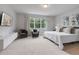 Serene main bedroom boasts plush carpeting, a large window, and a stylish sitting area with comfortable chairs at 17522 Hidden Forest Dr, Clermont, FL 34714