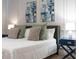 Comfortable main bedroom features a plush bed with decorative pillows and stylish nightstands with lamps at 17522 Hidden Forest Dr, Clermont, FL 34714