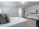 Bright main bedroom with plush carpeting, a large window, and a stylish entertainment center at 17522 Hidden Forest Dr, Clermont, FL 34714