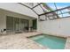 Outdoor patio area with a screened-in hot tub at 17522 Hidden Forest Dr, Clermont, FL 34714