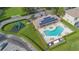 Aerial view of community pool, playground, and green space at 17522 Hidden Forest Dr, Clermont, FL 34714