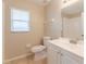 Bathroom features a vanity with white cabinets, tile flooring, and a toilet at 2104 Remington Pointe Blvd, Kissimmee, FL 34743