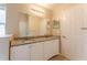 Bathroom showcasing a double vanity with granite countertop, ample mirror space, and neutral decor at 2104 Remington Pointe Blvd, Kissimmee, FL 34743