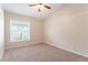 Bedroom featuring neutral carpeting, a vaulted ceiling, and a window overlooking the front yard at 2104 Remington Pointe Blvd, Kissimmee, FL 34743