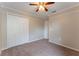 Bedroom featuring neutral carpeting, a standard closet, a ceiling fan, and neutral paint at 2104 Remington Pointe Blvd, Kissimmee, FL 34743