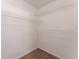 Walk-in closet with neutral walls and carpet, featuring metal shelving at 2104 Remington Pointe Blvd, Kissimmee, FL 34743