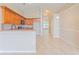 Open kitchen with wood cabinets and stainless steel oven flows into dining area with bright natural light at 2104 Remington Pointe Blvd, Kissimmee, FL 34743