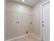 Laundry room with a tile floor, utility connections, and a door at 2104 Remington Pointe Blvd, Kissimmee, FL 34743