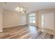 Bright and airy living room with vaulted ceilings, stylish wood flooring, and a large arched window at 2104 Remington Pointe Blvd, Kissimmee, FL 34743