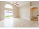 Bright living room boasts large windows and sliding glass door with access to backyard at 2104 Remington Pointe Blvd, Kissimmee, FL 34743