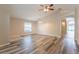 Inviting living room with wood floors, ceiling fan, archway, and view of the outdoors at 2104 Remington Pointe Blvd, Kissimmee, FL 34743