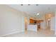Open-concept living area with tile flooring, high ceilings, and view into eat-in kitchen at 2104 Remington Pointe Blvd, Kissimmee, FL 34743