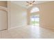 Sun-filled living room with sliding glass doors and neutral wall color at 2104 Remington Pointe Blvd, Kissimmee, FL 34743