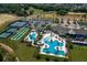 Overhead view of a community pool with palm trees, a clubhouse, and recreational facilities at 2168 Seagrass Pt # 424, Kissimmee, FL 34747