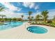 Resort-style pool and spa area featuring lush landscaping and multiple water features at 2168 Seagrass Pt # 424, Kissimmee, FL 34747