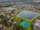 Wide aerial view of the community featuring lakes, recreational areas like basketball courts, and well-spaced residences at 218 Castlemain Cir, Davenport, FL 33897