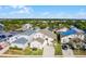 Well-maintained home with a manicured lawn, driveway, and mature landscaping, nestled in a vibrant neighborhood at 218 Castlemain Cir, Davenport, FL 33897