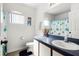 Bathroom with a single sink vanity and a shower/tub combination behind a glass door at 218 Castlemain Cir, Davenport, FL 33897