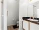 Well-lit bathroom featuring a single sink vanity and walk-in shower at 218 Castlemain Cir, Davenport, FL 33897