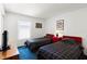 Comfortable bedroom with twin beds, red nightstands, and plush blue carpeting at 218 Castlemain Cir, Davenport, FL 33897