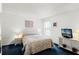Bright bedroom featuring a queen bed, neutral decor, and blue carpeting at 218 Castlemain Cir, Davenport, FL 33897