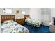 Inviting bedroom featuring two twin beds with floral bedspreads and blue carpeting at 218 Castlemain Cir, Davenport, FL 33897