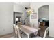 Dining room showcases a wood table for six, open to other living spaces at 218 Castlemain Cir, Davenport, FL 33897