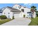 Charming two-story home featuring a well-manicured lawn and a driveway leading to a two-car garage at 218 Castlemain Cir, Davenport, FL 33897