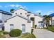 Inviting two-story home with a well-kept lawn, complemented by a palm tree in the front yard at 218 Castlemain Cir, Davenport, FL 33897