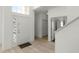 Bright foyer featuring wood-look flooring and a decorative door, leading into the home at 218 Castlemain Cir, Davenport, FL 33897