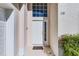 Close-up of front door featuring a sidelight and transom window allowing natural light into the home at 218 Castlemain Cir, Davenport, FL 33897