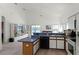 Kitchen boasts ample counter space, white cabinetry, open to the living room and entertainment area at 218 Castlemain Cir, Davenport, FL 33897
