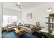 Cozy living room with comfortable seating, ceiling fan, natural light, and a functional workspace at 218 Castlemain Cir, Davenport, FL 33897