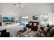 Inviting living room boasts a television, decor shelving, and access to the pool area at 218 Castlemain Cir, Davenport, FL 33897