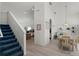 Open-concept living space showcasing stairs, dining area and a glimpse of the kitchen at 218 Castlemain Cir, Davenport, FL 33897