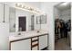 Clean main bathroom features a dual vanity and a walk-in closet for convenient storage at 218 Castlemain Cir, Davenport, FL 33897