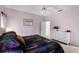 Charming main bedroom features a dresser and a scenic picture for a homey feel at 218 Castlemain Cir, Davenport, FL 33897