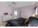 Bright main bedroom with open door and a dresser with a vase of flowers at 218 Castlemain Cir, Davenport, FL 33897