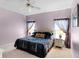Comfortable main bedroom with ceiling fan, side tables and decorative wall art at 218 Castlemain Cir, Davenport, FL 33897