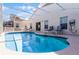 Inviting screened-in pool with clear water, lounge chairs, and outdoor seating area for relaxation at 218 Castlemain Cir, Davenport, FL 33897