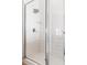Walk-in shower featuring white tiles and a glass door at 218 Castlemain Cir, Davenport, FL 33897
